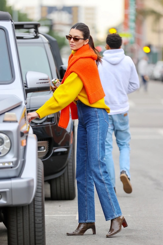 Kendall Jenner orange sweater and jeans